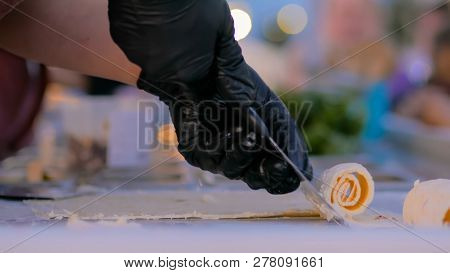 Chef Cooking Asian Natural Stir-fried Ice Cream Rolls At Freeze Pan. Outdoor Cooking, Gastronomy And