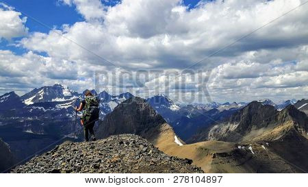A Female Hiker Backcountry Hiking Through The Remote, Secluded, And Beautiful Rocky Mountains In Kan