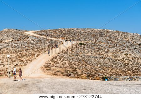 Sifnos, Greece - September 12, 2018: Tourists Walking Along The Path On The North Side Of The Island