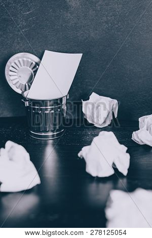 Garbage Bin On Desk Setting With Empty Notepad And Scrunched Paper Balls, Concept Of Drafting And St
