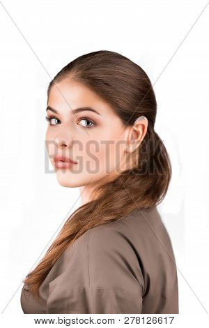 A Girl With A Hearing Aid. The Girl Assumes Hearing Aid. Isolated On White Background. Happy Girl Th