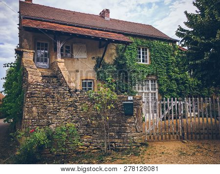 July 19, 2017. Village Ameugny France Burgundy Region In Summer. Old Stone Facade Of The Apartment B