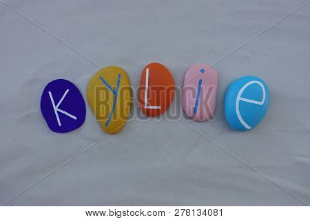 Kylie, Feminine Given Name Composed With Multi Colored Stones Over White Sand