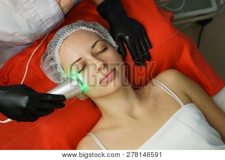 Hardware Cosmetology. Beautician Makes Ultrasonic Skin Tightening Client. Skin Pore Cleansing. Anti-
