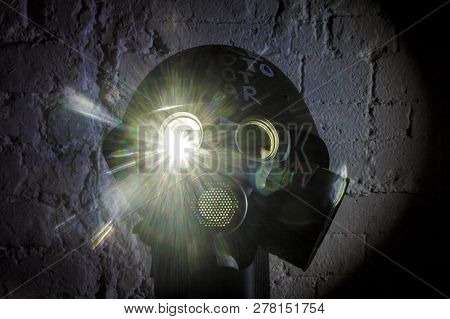 Art Picture Of A Military Gas Mask On A White Brick Wall With Shadows With Flash With The Inscriptio