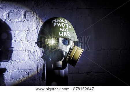 Art Picture Of A Military Gas Mask On A White Brick Wall With Shadows With Flash With The Inscriptio