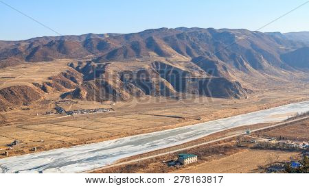 View Of The North Korean Territory Tumen Or Tumangan River In Tumen City Province Jilin Of China.