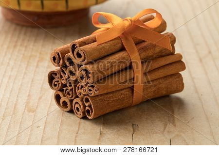 Bunch of cassia cinnamon sticks with an orange ribbon 