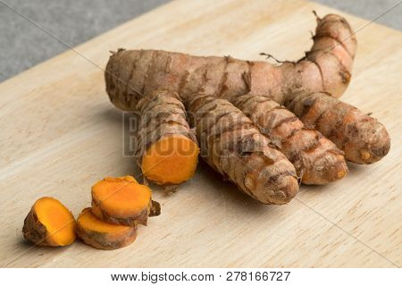 Fresh raw curcuma rhizome and slices close up