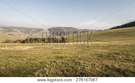 Autumn Landscape With Meadows, Hills Of Javorniky Village, Forest, Papradno Village And Blue Sky In 