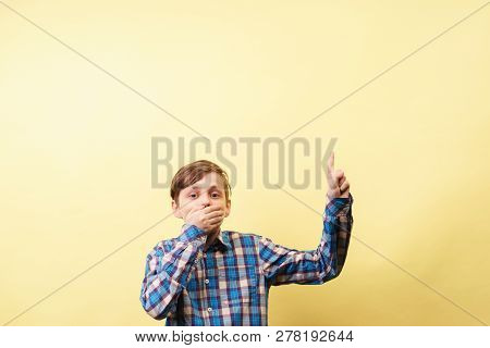 Omg Unbelievable Shock Amazement. Dumbfounded Boy Points With Index Finger At Empty Space Over Yello