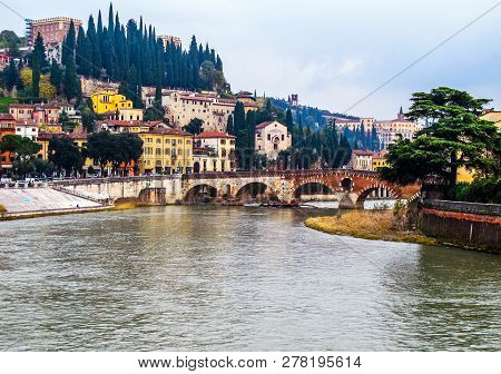 Beautiful View Of The Cityscape Of Verona Italy, The River Adige And The Historic Stone Bridge Ponte