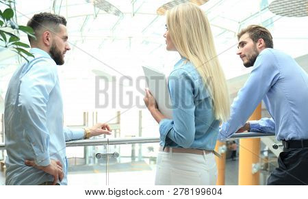 Young Modern Colleagues In Smart Casual Wear Having A Brainstorm Meeting While Standing In The Creat