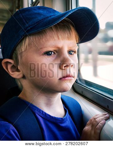 Sad Child Boy Sit In The Train By The Window