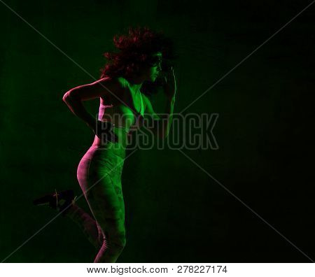 Young Sport Woman With Afro Hairstyle Running Jogging In Gyn In Green And Pink Neon Light On Dark Wa