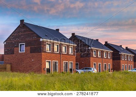 Street With Modern Family Houses In Urban Suburb In The Netherlands