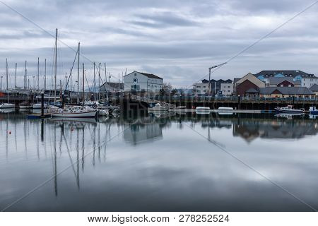Carrickfergus Harbour With Boats And Reflection ,antrim,northern Ireland, Uk