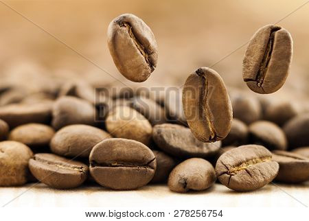 Flying Fresh Coffee Beans As A Background With Copy Space. Coffee Beans Falling Down.