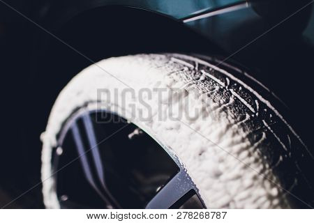 Car Care Or Car Detailing Process. Using Black Sponge To Washing The Tire. Blacker Rubber.