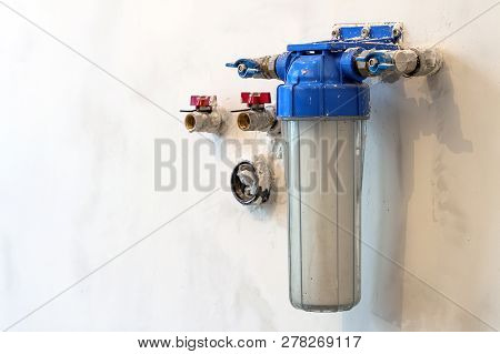Water Filter New Installed On A Kitchen Wall To Purify Drinking Water.