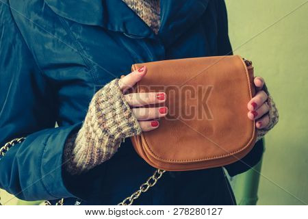 Girl Holding Leaser Clutch In Front Of Her Body