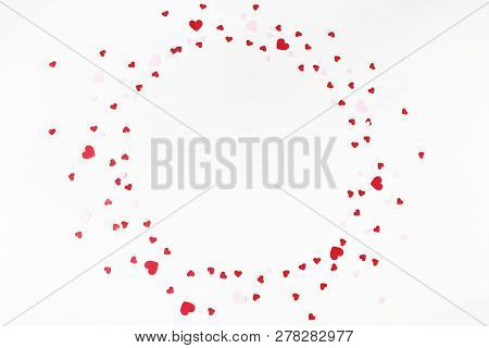Valentines Day Or Wedding Festive Composition. Circle Made Of Red And Pink Paper Heart Shaped Confet