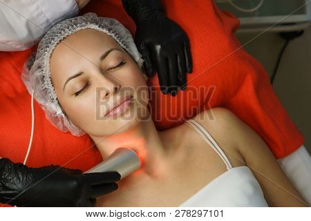 Hardware Cosmetology. Beautician Makes Ultrasonic Skin Tightening Client. Skin Pore Cleansing. Anti-