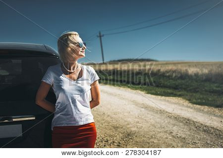 Adult Independent Woman Enjoys Road Adventure. Successful Woman Freedom Holidays Concept. Vacation, 