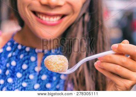 Mochi cake Asian woman in Japan eating japanese food dessert rice paste.