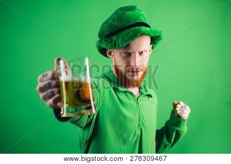 Man On Green Background Celebrate St Patricks Day. Portrait Of Excited Man Holding Glass Of Beer On 