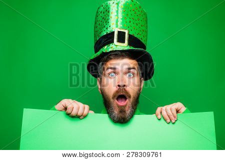 Green Patricks Background. Man In Saint Patricks Day Leprechaun Party Hat Having Fun On Green Backgr
