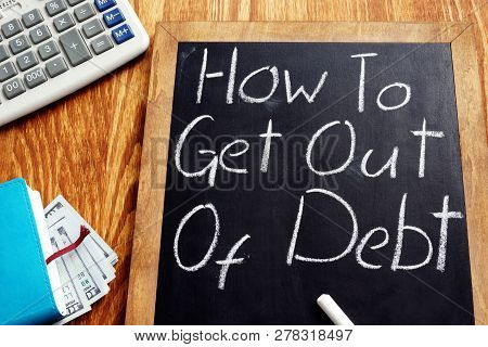 How To Get Out Of Debt Handwritten On A Blackboard.