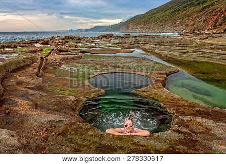Female Enjoys The Experience Of Figure 8 Pools On The Coastal Rock Shelf Near Sydney