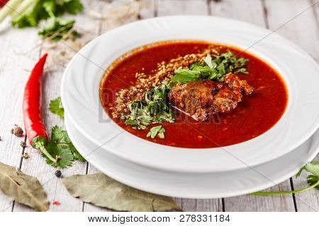 Traditional Georgian And Armenian Cuisine. Tomato Soup With Rice Harcho Of Lamb, With Walnut, Garlic
