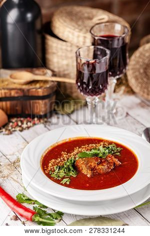 Traditional Georgian And Armenian Cuisine. Tomato Soup With Rice Harcho Of Lamb, With Walnut, Garlic