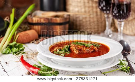 Traditional Georgian And Armenian Cuisine. Tomato Soup With Rice Harcho Of Lamb, With Walnut, Garlic