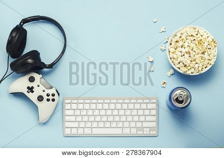 Keyboard And Tin Can With A Drink, Energy Drink, A Bowl Of Popcorn, A Gamepad And Headphones On A Bl