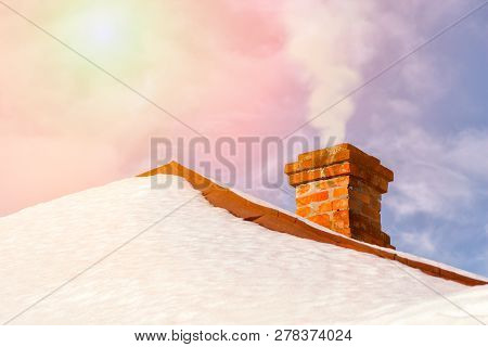 Smoke Raising From A Chimney In Snny Winter