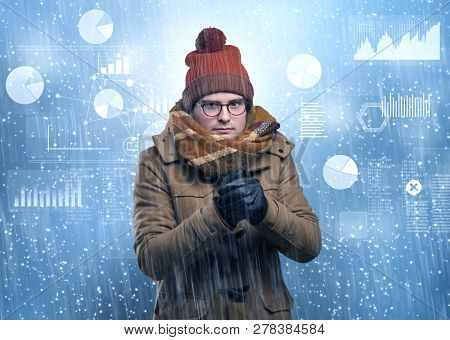 Young businessman shivering with graphs, reports and chart concept