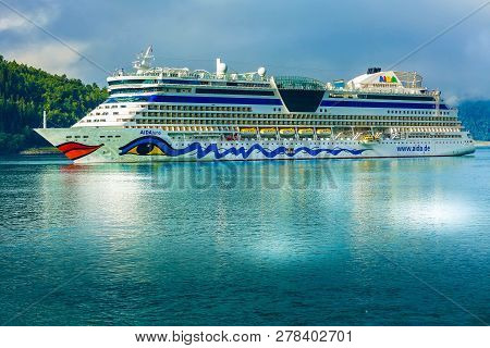 Olden, Norway - August 1, 2018: Aidaluna Cruise Ship In Norwegian Fjords And Summer Mountain Landsca