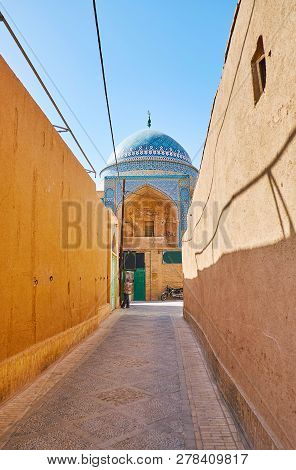 The Narrow Street Lined With Tall Adobe Walls Leads To The Bogheh-ye Seyed Roknaddin Mausoleum, Towe