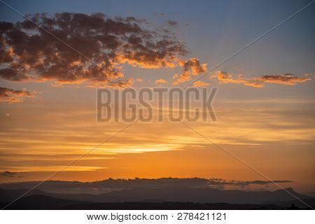 Golden Sunset On Different Layers Of Clouds.