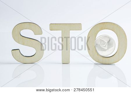 Security Token Offering Sto Sign With Wooden Letters And Silver Ethereum Coin Behind, Ethereum Conce