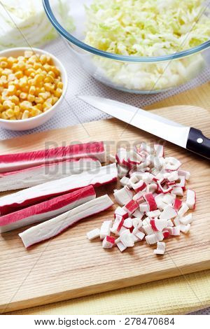 Surimi Sticks Cut On Wooden Cutting Board. Process Of Cooking Chinese Cabbage, Sweet Corn And Surimi