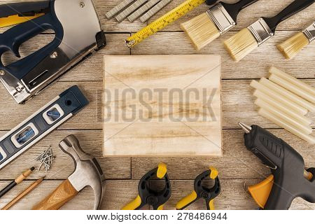 Set Of Construction Tools On A White Wooden Plank, Directly Above. Copy Space For Your Text.