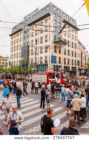 Vilnius, Lithuania - July 27, 2013: Crowd Of People Surrounding Fire Engine Car Driving At Beginning