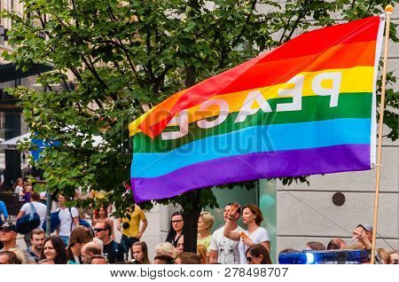 Vilnius, Lithuania - July 27, 2013: Pride Parade In Action. Famous Rainbow Peace Flag Above The Crow