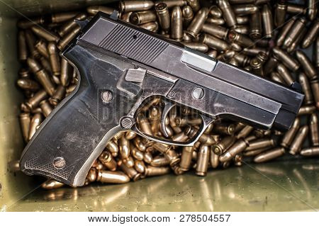 Top View Of Gun And Ammunition Box On The Table