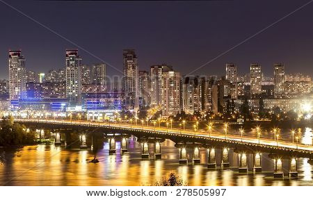 Kyiv (kiev) City, The Capital Of Ukraine At Night Beside The Dnipro (dniepr) River With Reflection I