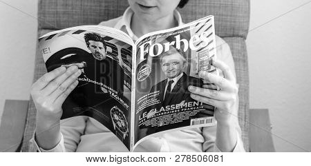 Paris, France - Mar 16, 2018: Black And White Image Of Young Business Woman Reading The Worlds Billi